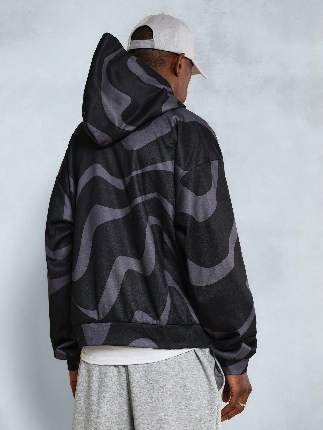 Oversized Fit Side Pocket Hoodie With All Over Swirl Print